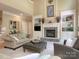 Living room with a cozy fireplace, built-in shelves and soaring ceilings at 155 Culpeze Rd, Mooresville, NC 28117