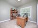 Functional home office featuring a large desk, a bookshelf, and natural light at 155 Culpeze Rd, Mooresville, NC 28117