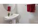 This powder room includes a pedestal sink, round mirror, and modern fixtures at 158 Snead Rd, Fort Mill, SC 29715