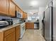 Spacious kitchen featuring stainless steel appliances, wooden cabinets, and tile flooring at 158 Snead Rd, Fort Mill, SC 29715