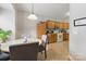 Cozy kitchen with wooden cabinetry, tile flooring, and a dining area for convenient meals at 158 Snead Rd, Fort Mill, SC 29715