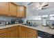 Efficient kitchen layout with wooden cabinets, stainless steel sink, and a view to the living area at 158 Snead Rd, Fort Mill, SC 29715