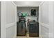 This laundry closet features a dark washer and dryer with shelving at 158 Snead Rd, Fort Mill, SC 29715
