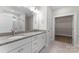 Bathroom with double vanity, granite countertop, white cabinets, and walk-in shower at 1651 Carolina Cir, Gastonia, NC 28054