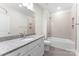 Modern bathroom featuring a granite countertop and a combined tub and shower with tiled walls at 1651 Carolina Cir, Gastonia, NC 28054