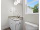 Clean bathroom with granite countertop, white cabinets, and modern fixtures at 1651 Carolina Cir, Gastonia, NC 28054