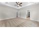 Spacious bedroom with tray ceiling, carpeted floors, with access to bathroom and closet at 1651 Carolina Cir, Gastonia, NC 28054