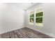 Bright bedroom featuring wood-look floors, light walls and a double window with green backyard view at 1651 Carolina Cir, Gastonia, NC 28054