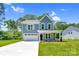 Charming two-story home featuring a manicured lawn, light blue siding, and a two-car garage at 1651 Carolina Cir, Gastonia, NC 28054