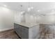 This kitchen features a large island with granite countertops and light gray cabinetry at 1651 Carolina Cir, Gastonia, NC 28054