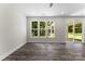 The sunlit living room has contemporary floors, three picture windows, and a glass sliding door at 1651 Carolina Cir, Gastonia, NC 28054