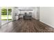 Open concept living room features kitchen with granite island and stainless steel appliances at 1651 Carolina Cir, Gastonia, NC 28054