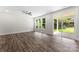 The sunlit living room features contemporary floors, three picture windows, and a glass sliding door at 1651 Carolina Cir, Gastonia, NC 28054
