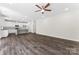 Open concept living room features kitchen with granite island and stainless steel appliances at 1651 Carolina Cir, Gastonia, NC 28054