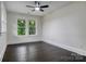 Cozy bedroom offers hardwood floors, a ceiling fan, and serene views of nature at 1783 Radio Station Rd, Newton, NC 28658