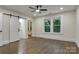 Bedroom with hardwood floors, ceiling fan, and ensuite bathroom with sliding door at 1783 Radio Station Rd, Newton, NC 28658