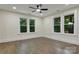 Inviting bedroom with hardwood floors, ceiling fan, and natural light from large windows at 1783 Radio Station Rd, Newton, NC 28658