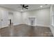Spacious bedroom featuring hardwood floors, ceiling fan, fireplace, and neutral paint at 1783 Radio Station Rd, Newton, NC 28658