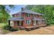 Elegant brick home featuring a classic design, covered porch, and symmetrical windows, exuding timeless charm at 1783 Radio Station Rd, Newton, NC 28658