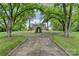 Brick home viewed from a circular drive with mature trees and manicured lawns, offering a grand entrance at 1783 Radio Station Rd, Newton, NC 28658