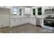 Modern kitchen features white cabinets, stainless steel appliances, and granite counters at 1783 Radio Station Rd, Newton, NC 28658