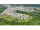 Expansive aerial shot of a well-planned residential neighborhood with tree-lined streets at 196 Sutters Mill Dr, Troutman, NC 28166
