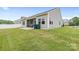 View of backyard featuring a screened porch and well maintained lawn at 196 Sutters Mill Dr, Troutman, NC 28166