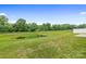Spacious backyard view with a tranquil pond surrounded by lush greenery at 196 Sutters Mill Dr, Troutman, NC 28166