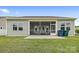 Spacious backyard with a screened patio, outdoor seating, and lush green grass, perfect for enjoying the outdoors at 196 Sutters Mill Dr, Troutman, NC 28166