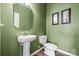 Stylish half bathroom featuring a pedestal sink, toilet, and modern finishes at 196 Sutters Mill Dr, Troutman, NC 28166