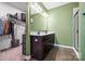 Well-lit bathroom featuring a double sink vanity, a mirror, with a walk-in closet providing ample storage at 196 Sutters Mill Dr, Troutman, NC 28166