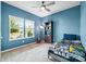 Cozy bedroom with ample natural light, ceiling fan, and Star Wars themed comforter at 196 Sutters Mill Dr, Troutman, NC 28166