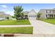 Charming two-story home boasts a manicured lawn, stone accents, and an attached two-car garage at 196 Sutters Mill Dr, Troutman, NC 28166