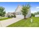 Charming two-story home boasts a manicured lawn, stone accents, and an attached two-car garage at 196 Sutters Mill Dr, Troutman, NC 28166