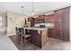 Kitchen with dark wood cabinets, stainless steel appliances, and island with counter seating at 196 Sutters Mill Dr, Troutman, NC 28166