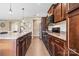 Kitchen with stainless steel appliances, granite countertops, and dark wood cabinetry at 196 Sutters Mill Dr, Troutman, NC 28166