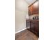 This kitchenette boasts rich, wood cabinets, a tiled backsplash, and durable laminate flooring for a touch of warmth and practicality at 196 Sutters Mill Dr, Troutman, NC 28166