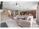 Inviting open-concept living room with a large sectional sofa, ceiling fan, and seamless flow into the modern kitchen at 196 Sutters Mill Dr, Troutman, NC 28166