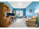 Bright office with comfortable couch, large desk with dual monitors, and natural lighting at 196 Sutters Mill Dr, Troutman, NC 28166