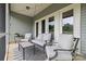 Relaxing covered patio featuring comfortable seating, a coffee table, an outdoor rug, and soft lighting for evening enjoyment at 196 Sutters Mill Dr, Troutman, NC 28166