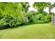 A beautifully landscaped backyard with lush greenery and mature trees at 2132 Cubla Ct, Rock Hill, SC 29732