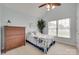 This bedroom features blue walls, a large window, and a ceiling fan at 2132 Cubla Ct, Rock Hill, SC 29732