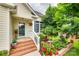 Inviting front porch featuring lovely flower beds and brick steps for a welcoming entrance at 2132 Cubla Ct, Rock Hill, SC 29732