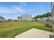 Expansive backyard with green lawn, concrete patio, and black metal fence, perfect for outdoor activities at 223 Haddonsfield Dr, Mooresville, NC 28115
