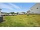 Large, grassy backyard with a black fence, ideal for outdoor activities and entertaining at 223 Haddonsfield Dr, Mooresville, NC 28115