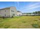 Expansive backyard with lush green grass and privacy fence, perfect for relaxation and recreation at 223 Haddonsfield Dr, Mooresville, NC 28115