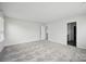 An empty bedroom with carpet floor, a window and a door at 223 Haddonsfield Dr, Mooresville, NC 28115