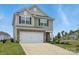 Charming two-story home featuring a stone-accented facade, attached garage, and well-maintained landscaping at 223 Haddonsfield Dr, Mooresville, NC 28115