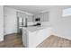 Modern kitchen with stainless steel appliances, gray cabinets, and a kitchen island at 223 Haddonsfield Dr, Mooresville, NC 28115