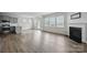 Spacious living room with a cozy fireplace, large windows, and modern flooring at 223 Haddonsfield Dr, Mooresville, NC 28115